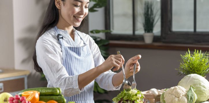 happy-woman-preparing-healthy-salad-kitchen-1-2