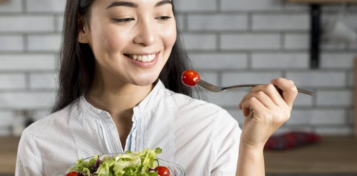 close-up-happy-asian-woman-eating-healthy-salad-1-2