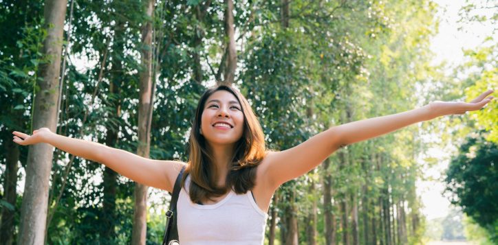 happy-young-asian-woman-traveler-with-backpack-walking-forest-1-2