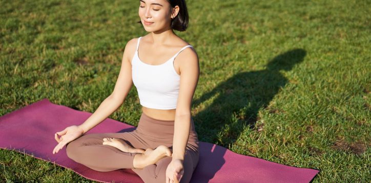 portrait-smiling-asian-woman-meditating-doing-yoga-fresh-air-relaxing-rubber-mat-exercising-1-2